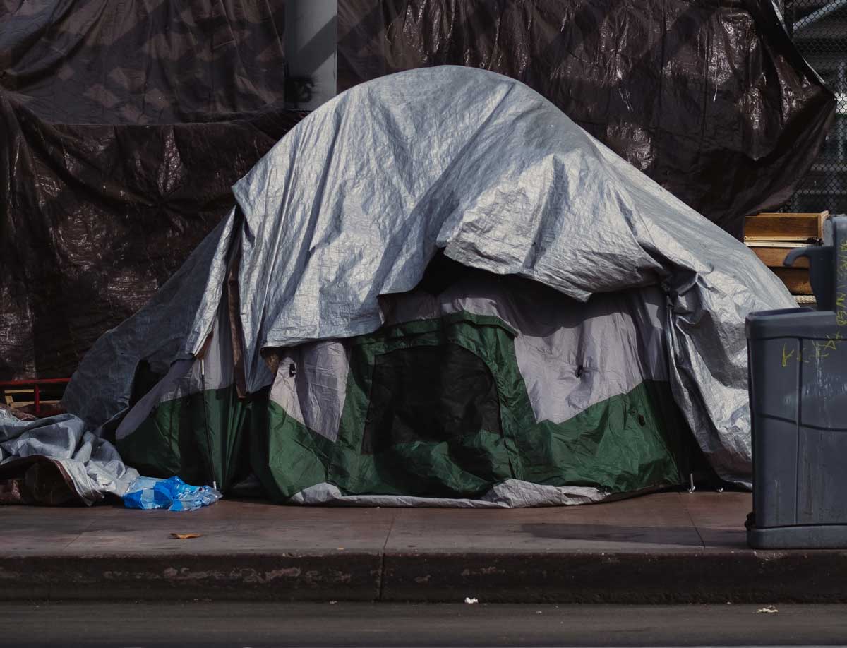 Tent set up on side of road for a homeless person